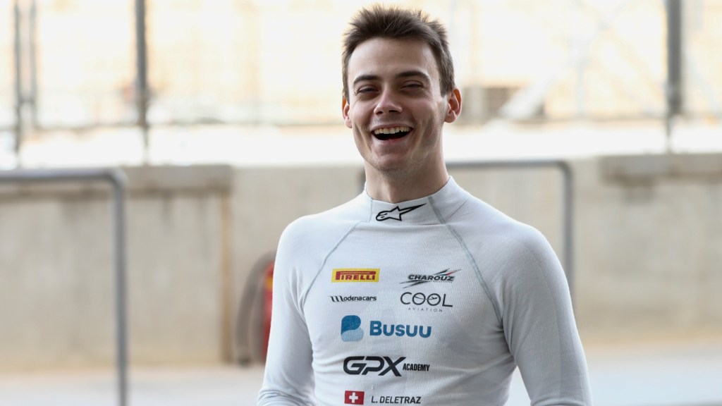 Delétraz smiling at the camera wearing a Charouz racing suit