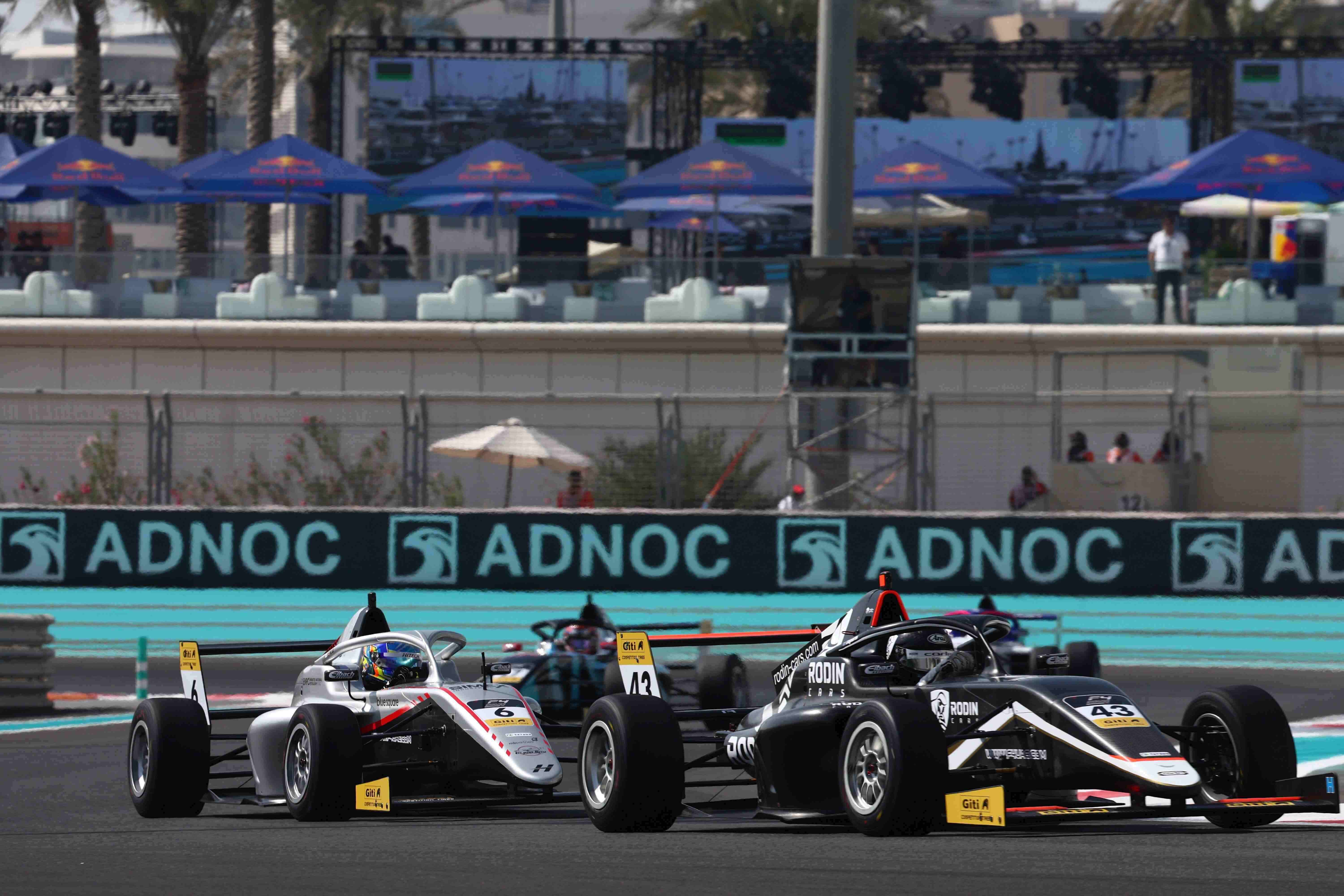 A black car driven by Costa Toparis negotiates a left turn as a silver car driven by Kanato Le pursues