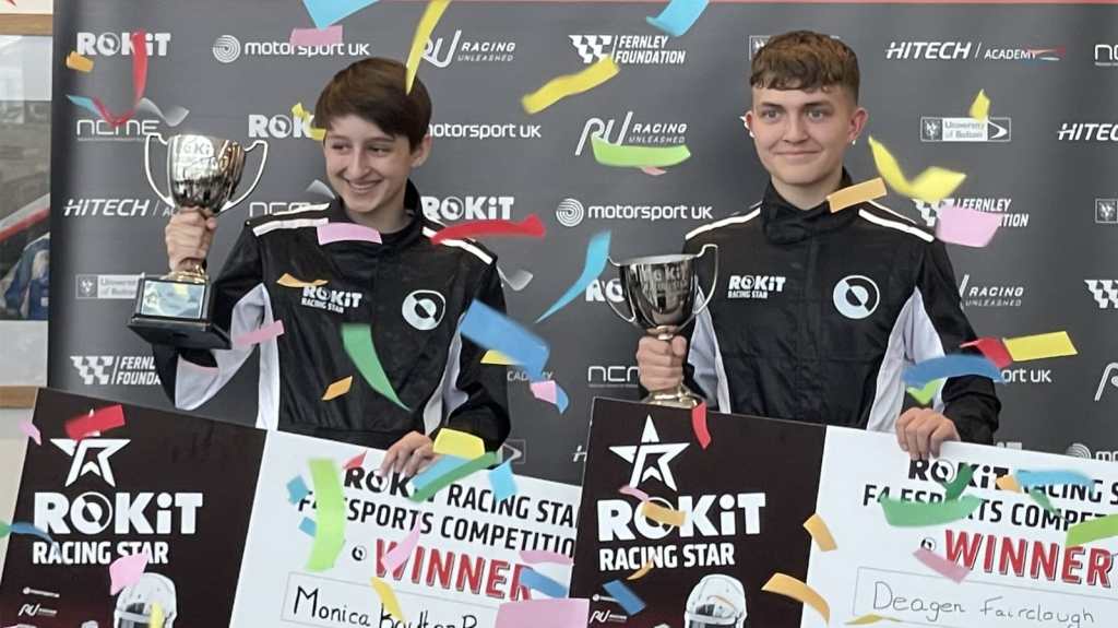 Monica Boulton Ramos and Deagen Fairclough hold black and white posters with their names and the text "ROKiT Racing Star F4 esports competition: WINNER" written on them. They hold trophies in their right hands as a shower of confetti falls in the foreground.