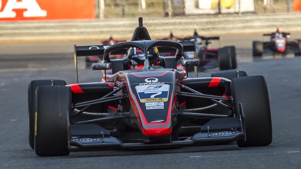 Jack Doohan on track in the F3 Asian Winter Championship driving a black and red car