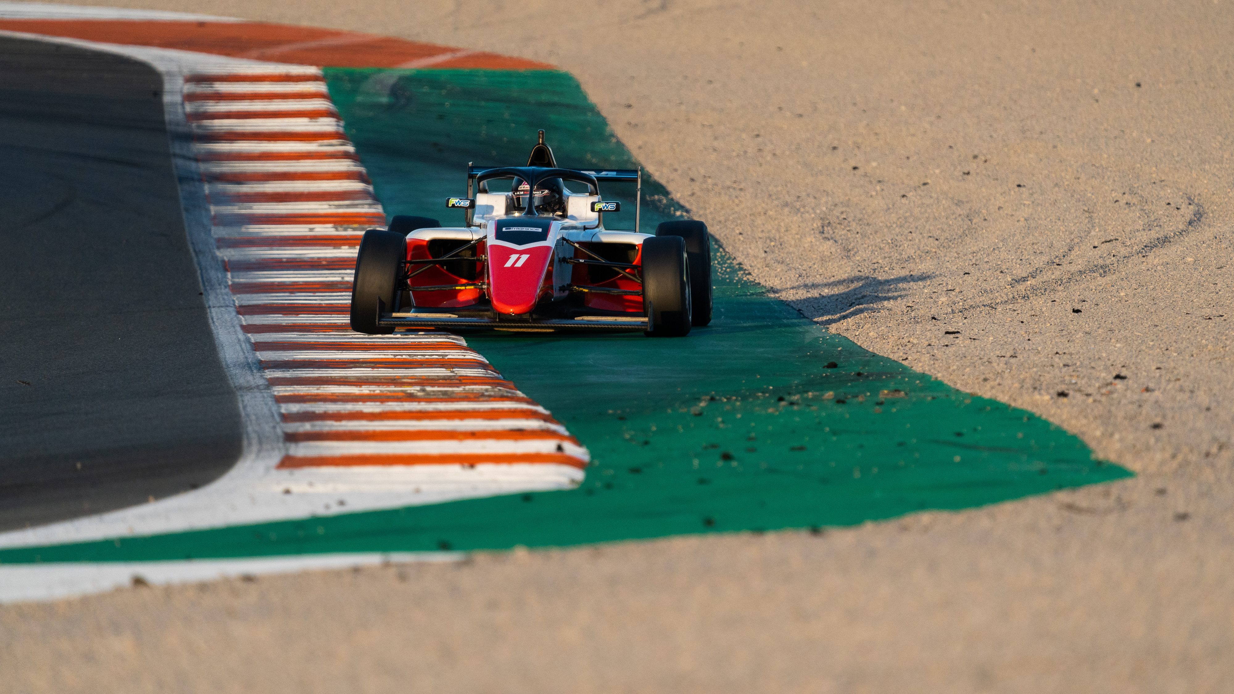 Red, white and black car on track in Valencia