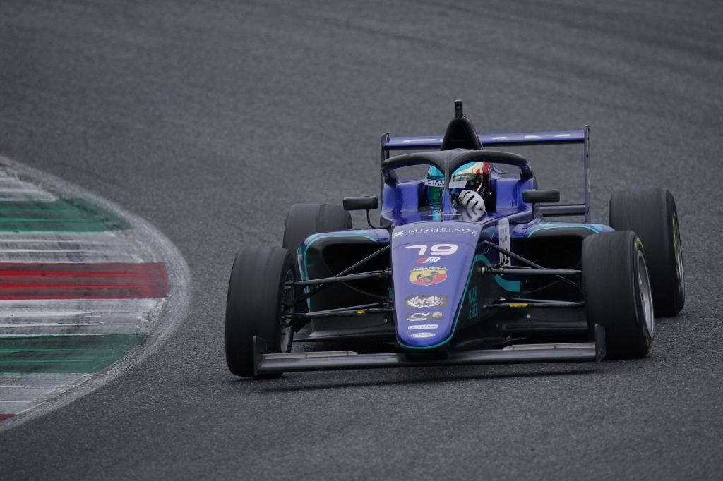 A puple Italian F4 car on track