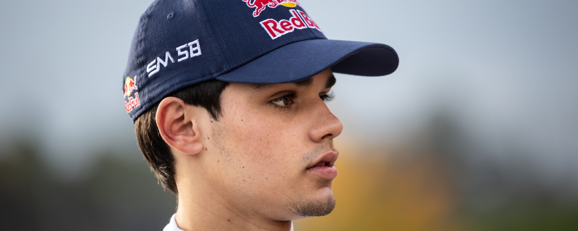Sebastián Montoya, wearing a Red Bull cap, looks to the right