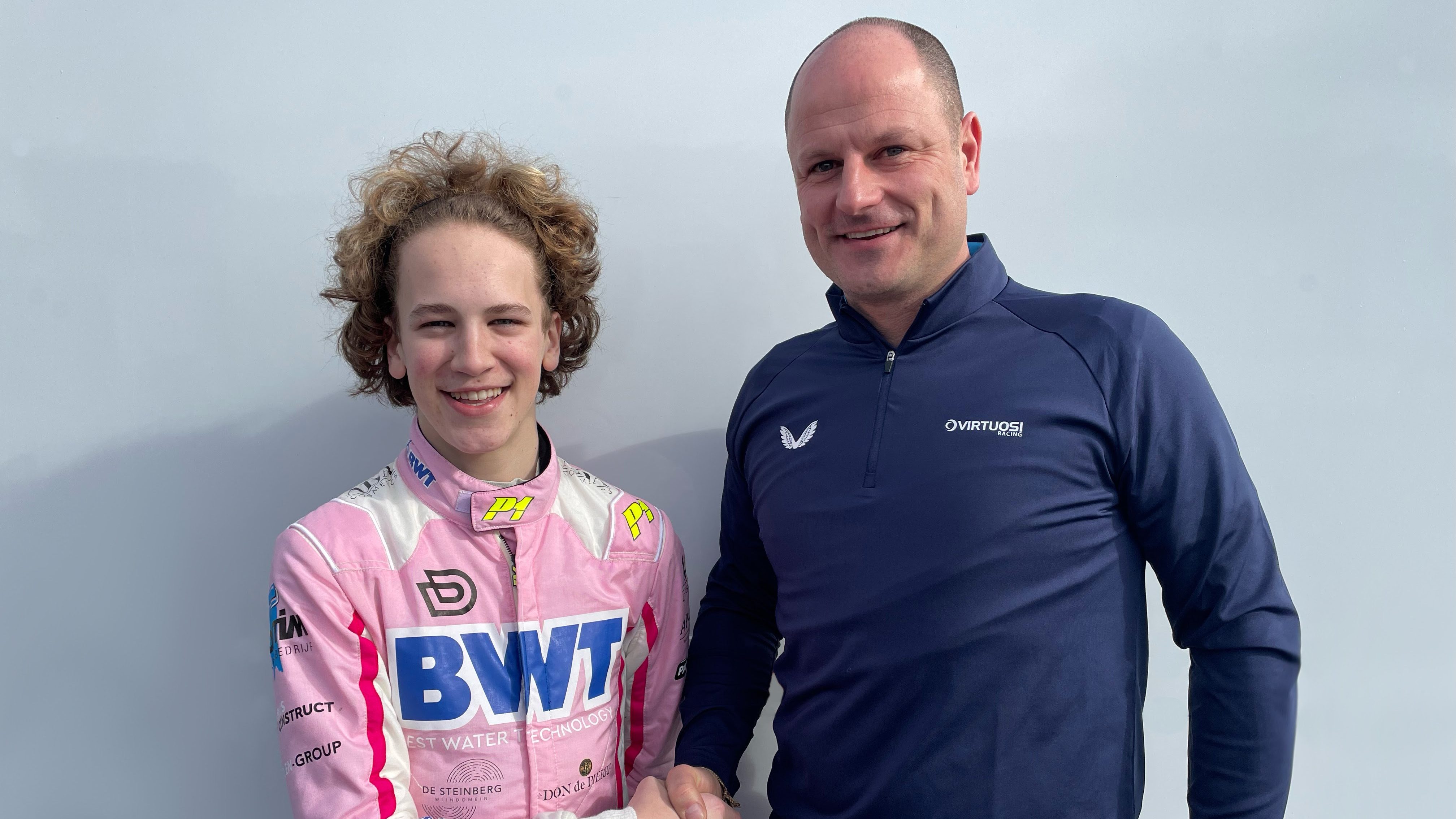 Dedecker and a member of the Virtuosi team stood side by side