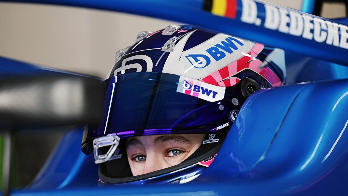 Dedecker in car with race helmet on 