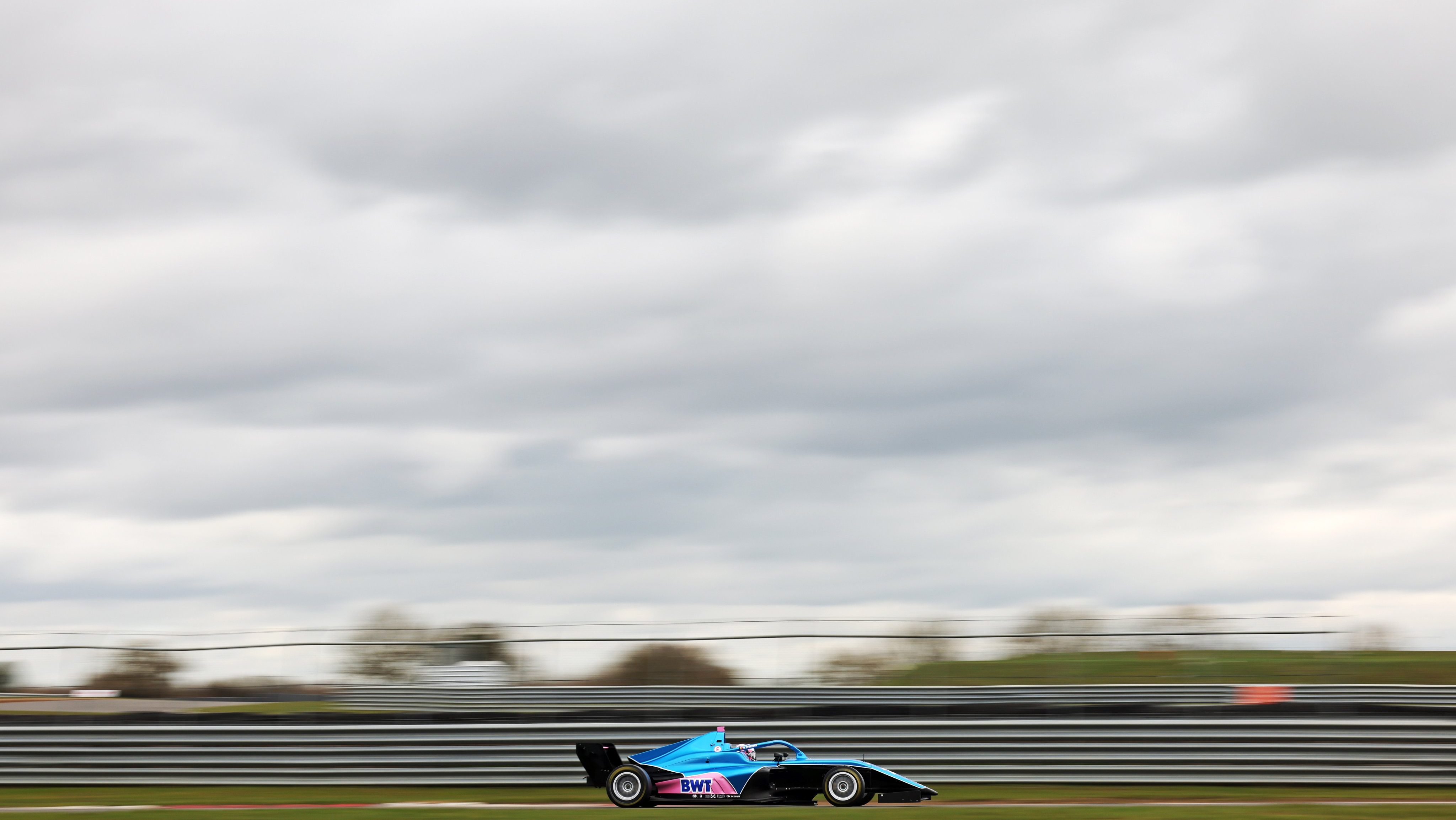 Blue and pink car on track