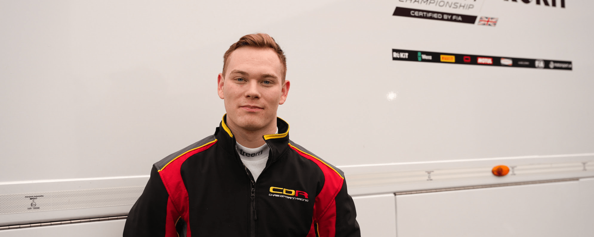 Daniel Guinchard stood in front of F4 British Championship sign