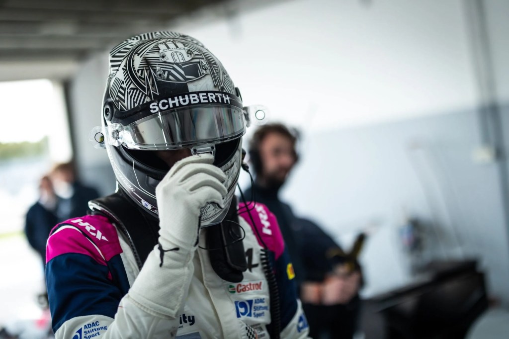 Tim Tramnitz grabs his helmet visor in the garage