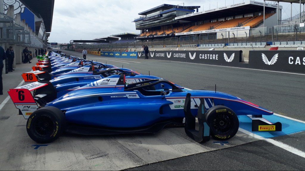 French F4 cars lined up on pit lane at Le Mans, facing to the right