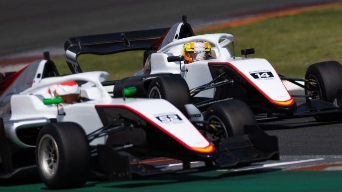 Two white and black cars side by side