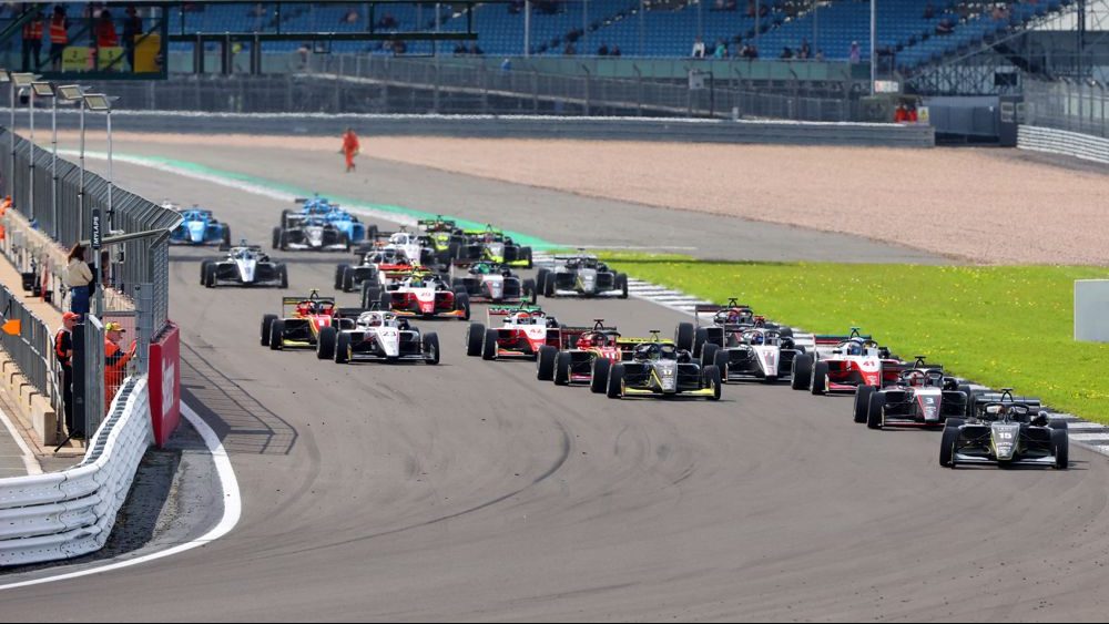 A grid of cars off the line shot from the front