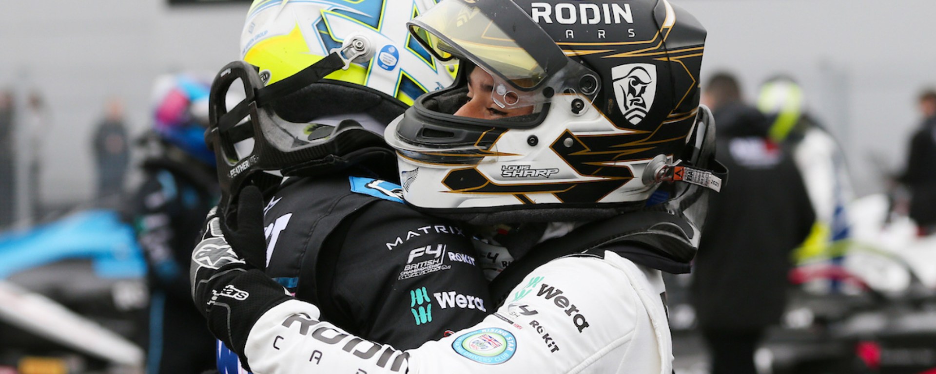 Aiden Neate (left) and Louis Sharp (right) hug in parc fermé while in race kit