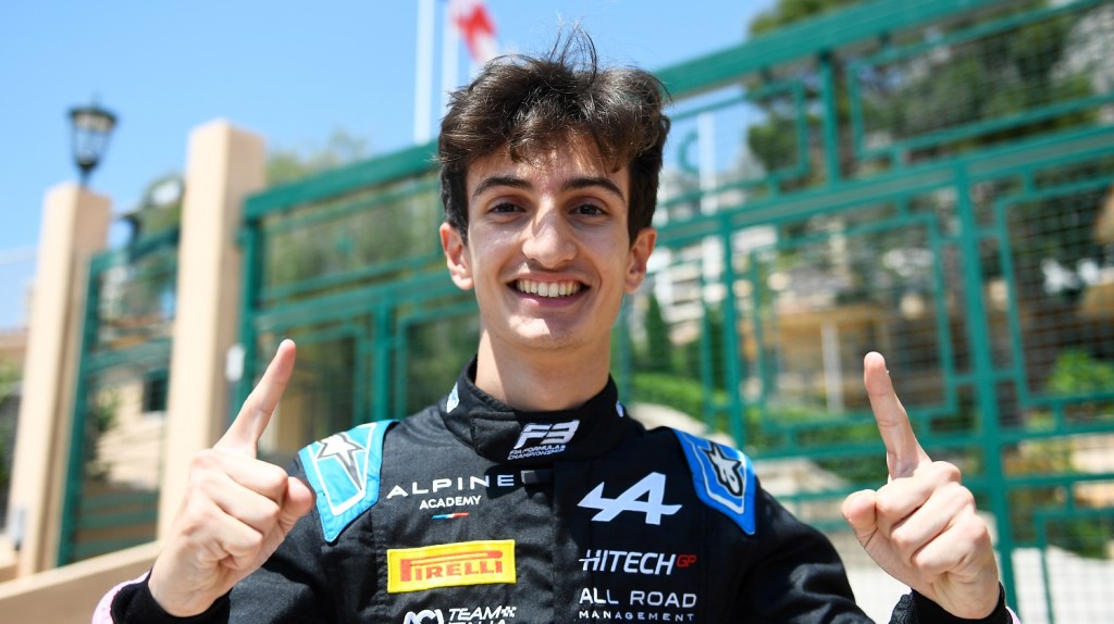 Gabriele Minì smiles with two index fingers in the air