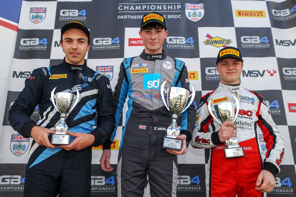 Evans GP's Cooper Webster (left), KMR Sport's Tom Mills (centre), and Fortec Motorsport's Colin Queen stand on the podium after Race 2 of the GB4 Silverstone round.