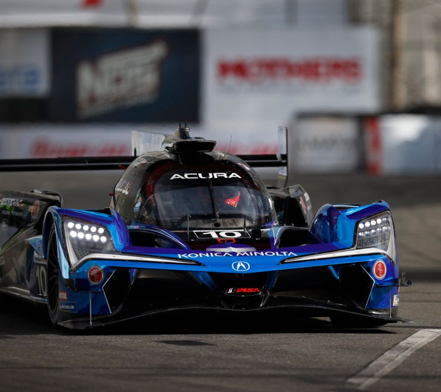 A blue and black grand touring prototype facing the camera