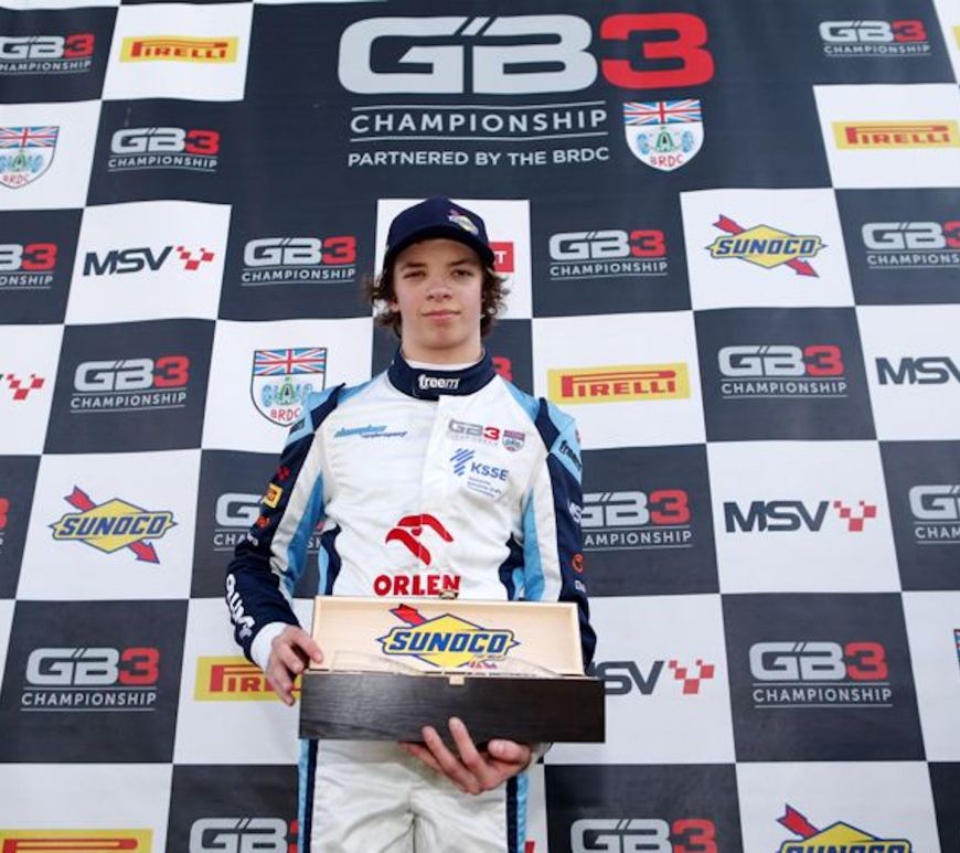 Tymek Kucharczyk holding a prize for the fastest driver of the weekend award given by GB3