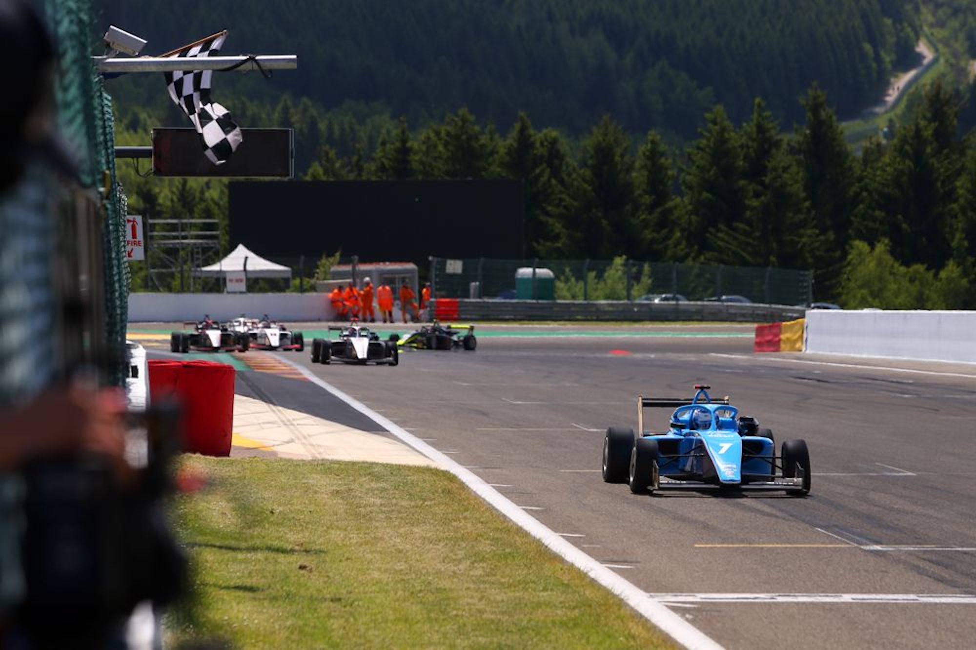 A blue car crossing the