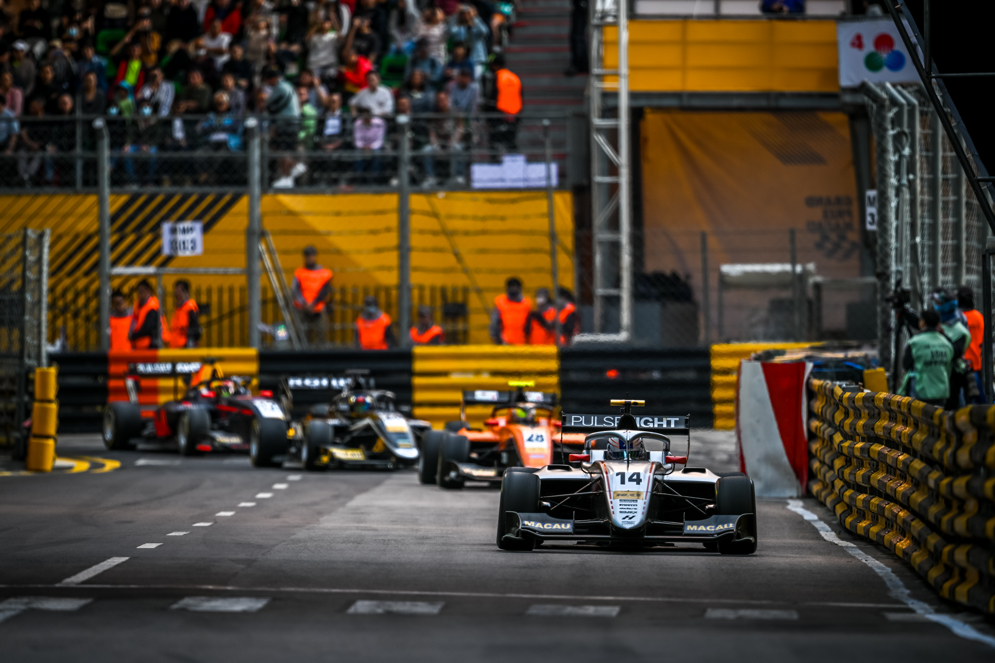 A gray car followe dby others