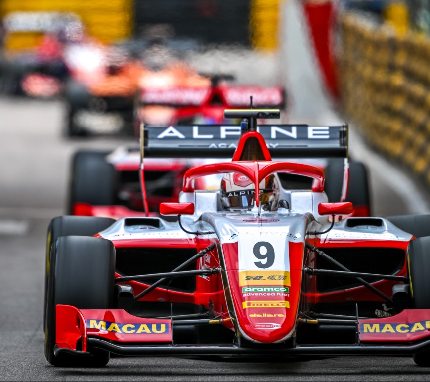 A red and white car going straight, pursued by others in the background