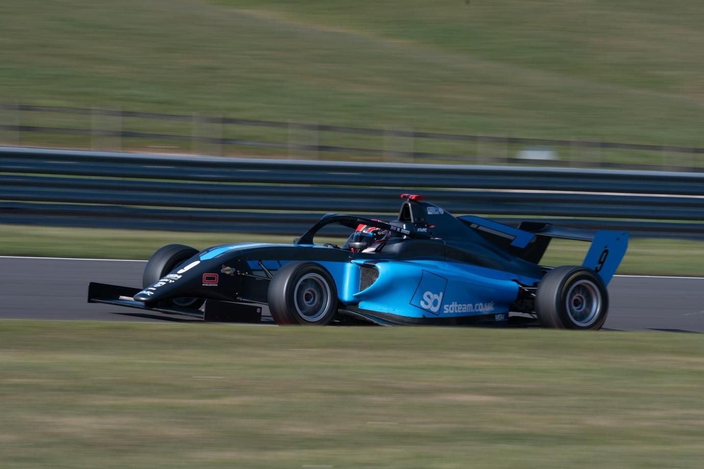 A blue race car on a track

AI-generated content may be incorrect.